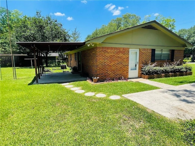 exterior space with a lawn and a carport