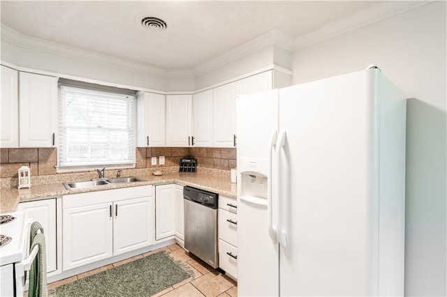 kitchen with backsplash, white cabinetry, sink, and white appliances