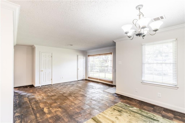 spare room featuring a textured ceiling, plenty of natural light, dark hardwood / wood-style floors, and an inviting chandelier