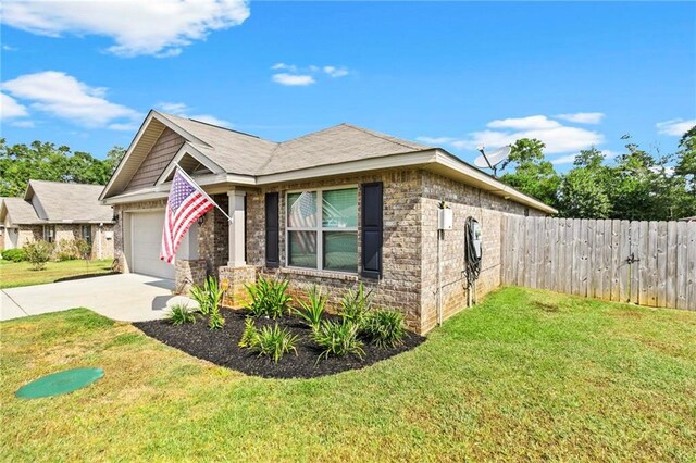 view of side of property with a garage and a lawn