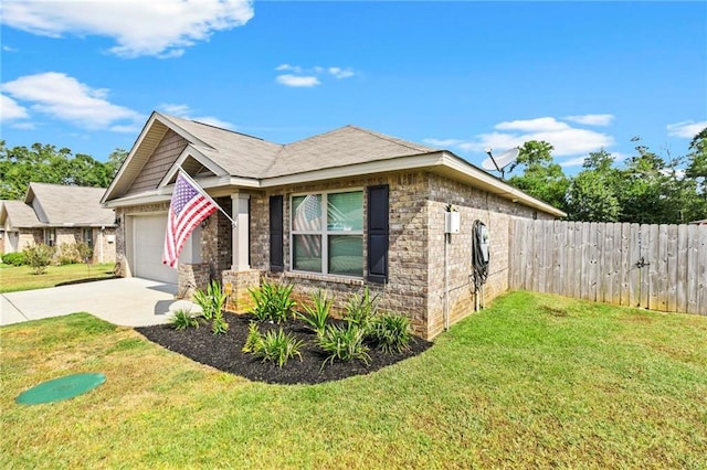 view of front of home with brick siding, an attached garage, a front yard, fence, and driveway