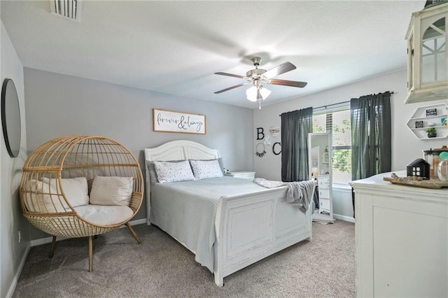 bedroom with light carpet, baseboards, visible vents, and ceiling fan