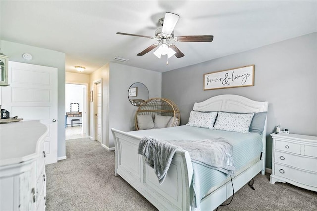 bedroom with light colored carpet, visible vents, ceiling fan, and baseboards