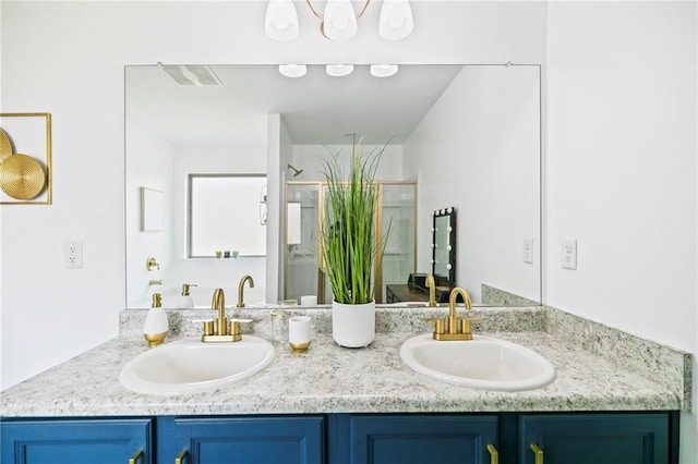 full bathroom featuring a stall shower, visible vents, a sink, and double vanity