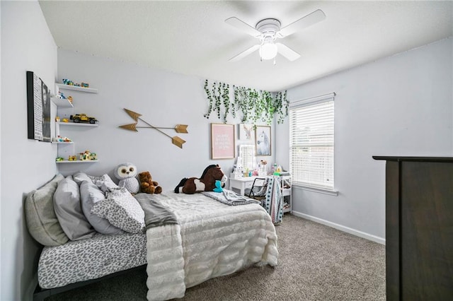 carpeted bedroom with a ceiling fan and baseboards