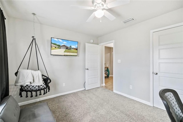 carpeted bedroom with a ceiling fan, visible vents, and baseboards