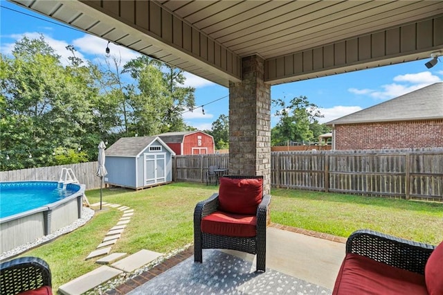 exterior space with a fenced in pool, an outbuilding, a storage unit, a patio area, and a fenced backyard