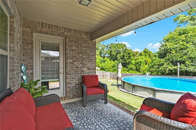 view of patio / terrace with a fenced in pool and fence