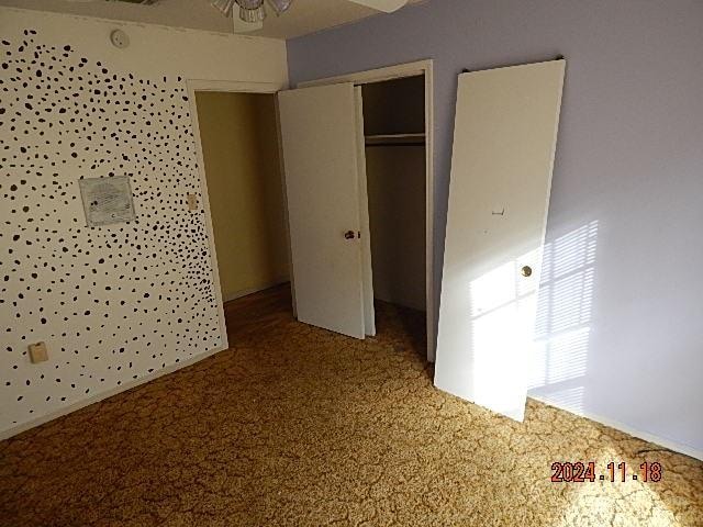 unfurnished bedroom with carpet flooring and a closet