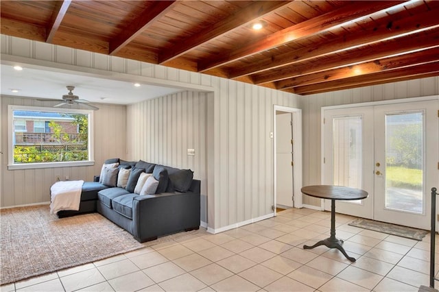 living room with wooden ceiling, french doors, ceiling fan, beam ceiling, and light tile patterned flooring