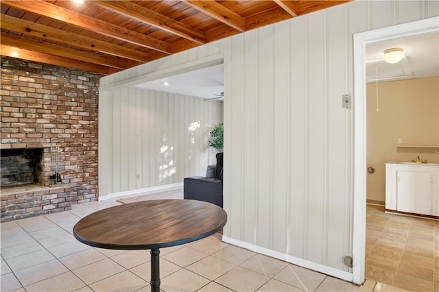 interior space with beam ceiling, wooden ceiling, sink, and light tile patterned floors