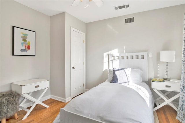 bedroom with ceiling fan and wood-type flooring