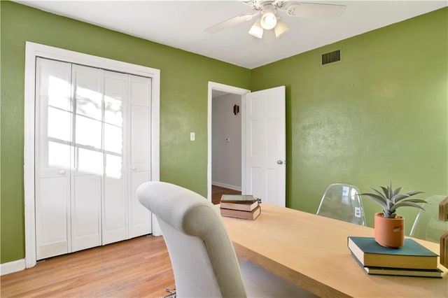 home office featuring light hardwood / wood-style floors and ceiling fan