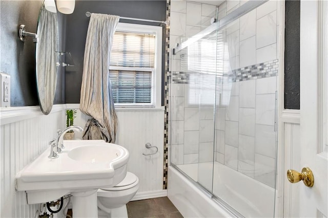 full bathroom with tile patterned floors, toilet, enclosed tub / shower combo, and sink