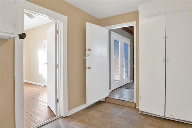 hallway featuring french doors and light hardwood / wood-style floors