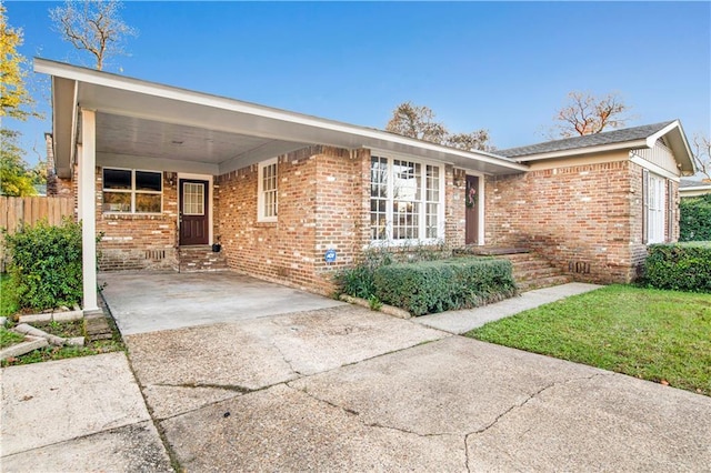 ranch-style home with a front lawn and a carport