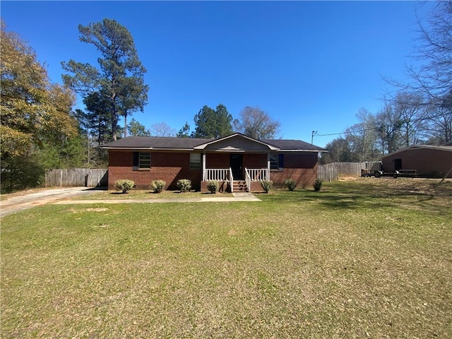 single story home featuring a front yard, covered porch, fence, and brick siding