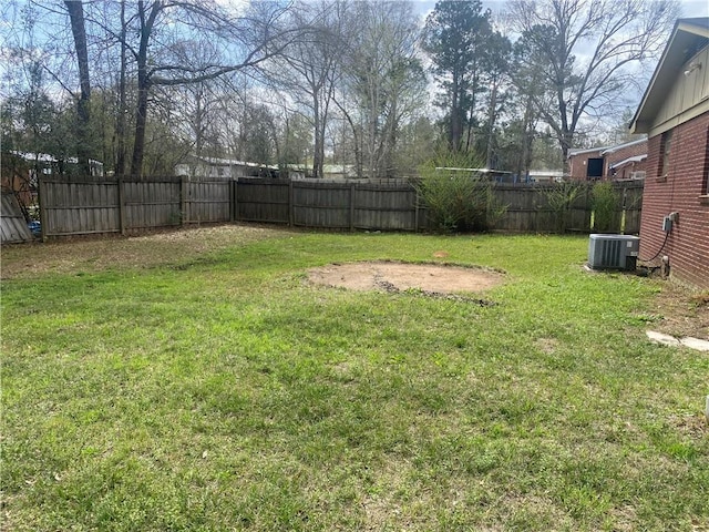 view of yard featuring central AC unit and fence private yard