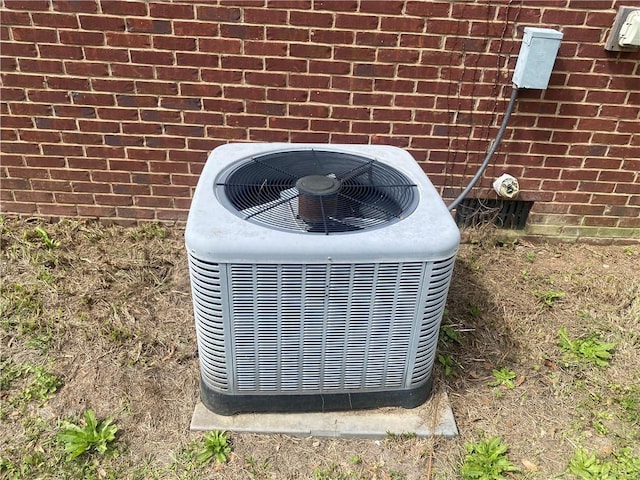 details featuring brick siding and central AC