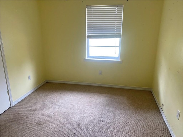 empty room with baseboards and carpet