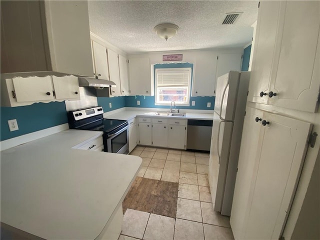 kitchen featuring visible vents, light countertops, stainless steel appliances, a textured ceiling, and a sink