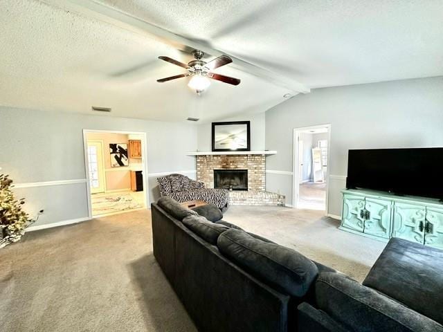 living area featuring visible vents, a textured ceiling, a brick fireplace, and carpet flooring