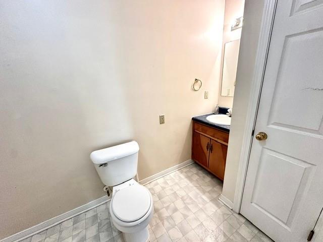 bathroom with tile patterned floors, toilet, vanity, and baseboards