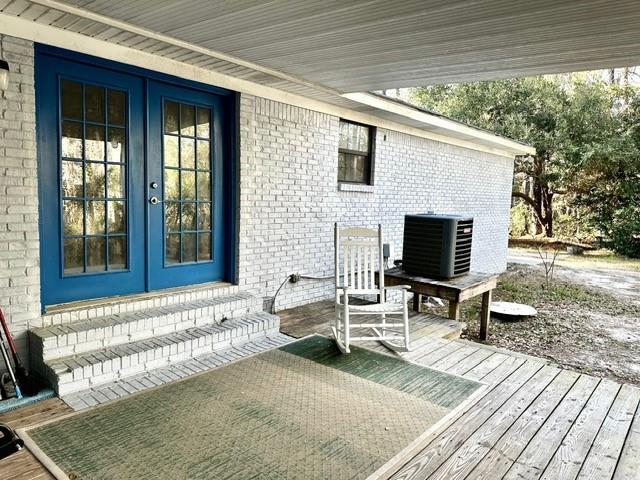 wooden deck with cooling unit and french doors