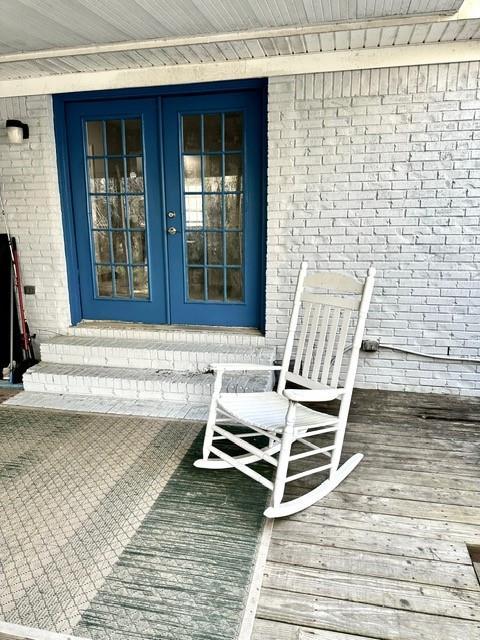 wooden terrace featuring french doors and entry steps