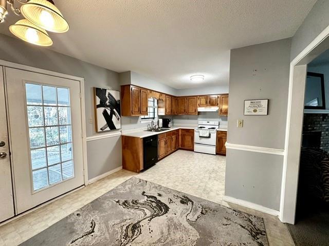 kitchen featuring brown cabinets, electric stove, a sink, black dishwasher, and light countertops