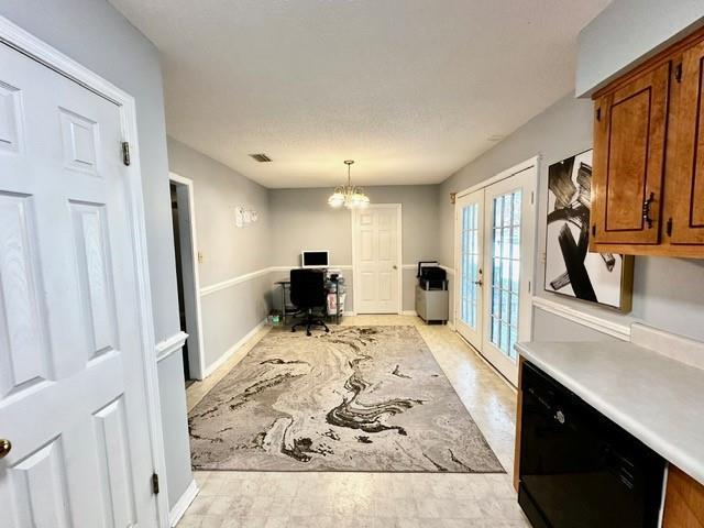 office area with an inviting chandelier, french doors, and visible vents