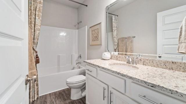 full bathroom with vanity, toilet, wood finished floors, and shower / tub combo with curtain