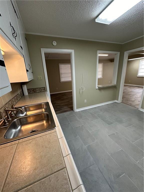 5405 Moffett Rd, Mobile, AL 36618 - kitchen with a textured ceiling, crown molding, and a sink