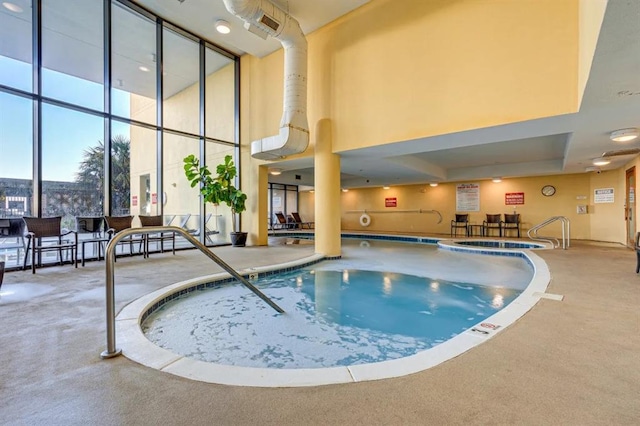 community pool featuring an indoor in ground hot tub