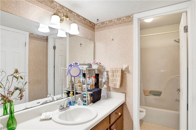 2805 Brookside Dr, Mobile, AL 36693 - full bathroom featuring toilet, vanity, a textured ceiling, and washtub / shower combination