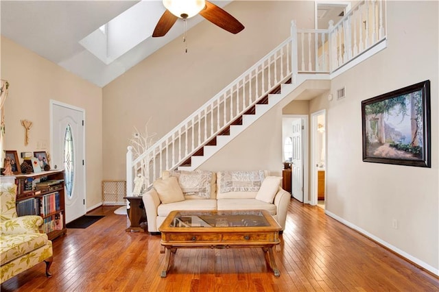 2805 Brookside Dr, Mobile, AL 36693 - living room featuring hardwood / wood-style floors, ceiling fan, high vaulted ceiling, and a skylight
