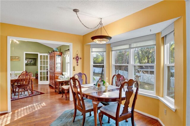 2805 Brookside Dr, Mobile, AL 36693 - dining space with a textured ceiling, hardwood / wood-style flooring, and plenty of natural light