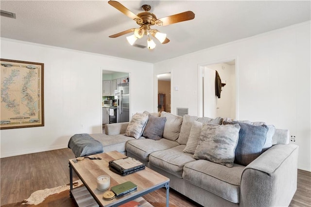 living area featuring a ceiling fan, wood finished floors, and visible vents