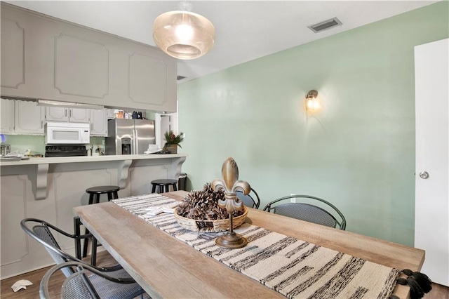 dining room featuring visible vents