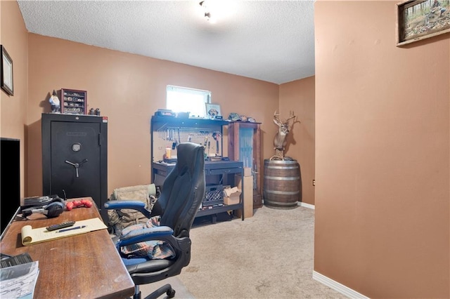 home office featuring baseboards, a textured ceiling, and carpet