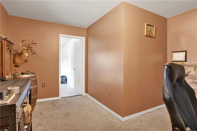 home office with baseboards, carpet flooring, and a textured ceiling