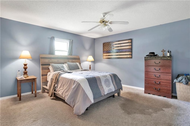 bedroom featuring a textured ceiling, carpet flooring, and a ceiling fan