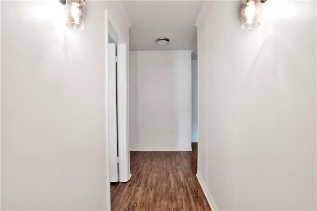 hall with wood finished floors and baseboards