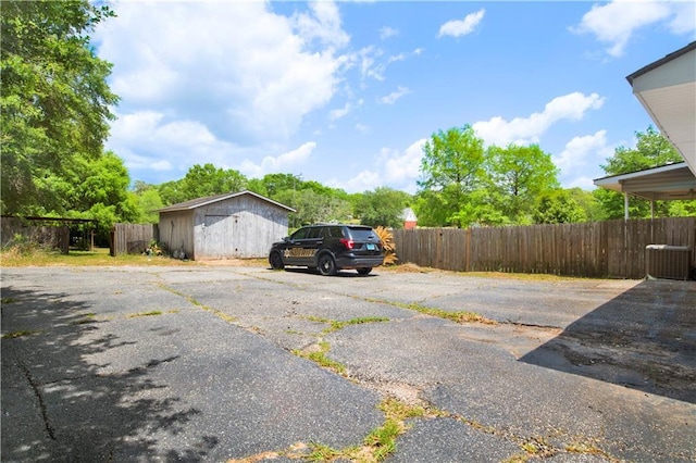 view of parking / parking lot featuring fence