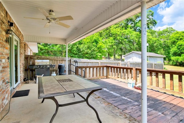 view of patio / terrace featuring a fenced backyard, a grill, ceiling fan, a deck, and outdoor dining area