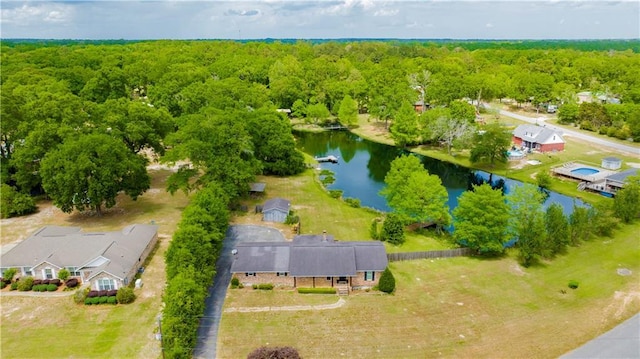 aerial view featuring a forest view and a water view