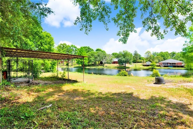 view of yard featuring a detached carport and a water view