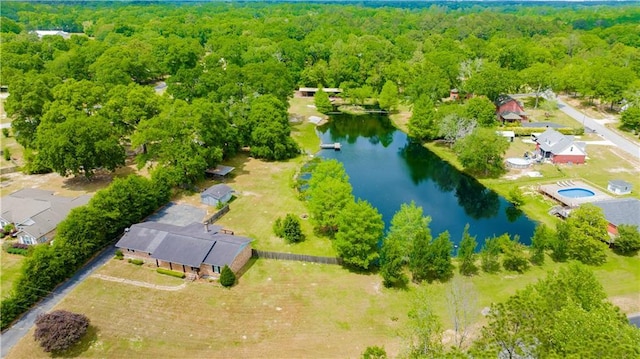 aerial view with a forest view and a water view