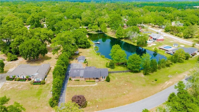 bird's eye view with a wooded view and a water view