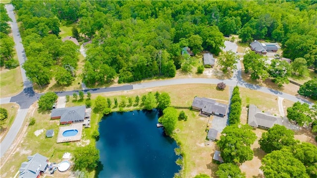 aerial view with a wooded view and a water view